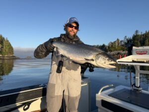 Joe Pyburn holding a big salmon on a boat